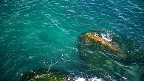 Top view of waves hitting by rocks. Beautiful ocean waves slow motion. Stock Footage 129273729