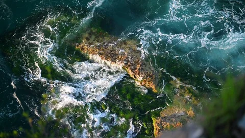 Top view of waves hitting by rocks. Beautiful ocean waves slow motion. Stock Footage 129273866