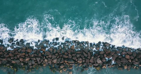 Top view of waves hitting stone breakwater at sea Stock Footage 105497207