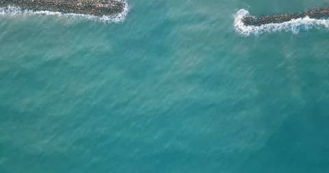 Top view of waves hitting stone breakwater at sea Stock Footage 105497247