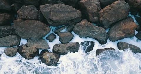 Top view of waves hitting stone breakwater at sea Stock Footage 105497261