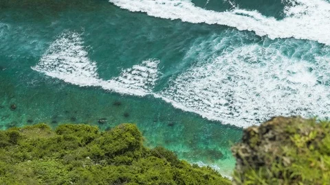 Top view of waves rolling one by one to the Nunggalan Beach, Uluwatu, Bali Stock Footage 122177333
