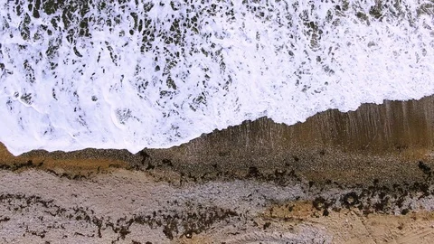 Top view of the waves of the sea with foam in the sand ejected algae Stock Footage 105747963