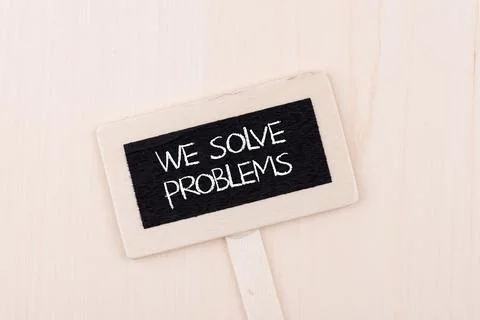 Top view of the "we solve problems" signboard on a wooden background 写真素材