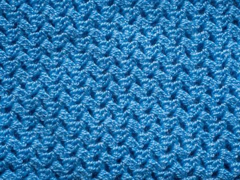 Top view weave patterned surface blue knitted wool fabric closeup texture bac Stock Photos