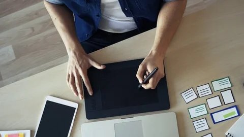 Top view of web designer sketching graphic on tablet Stock Footage 72875403