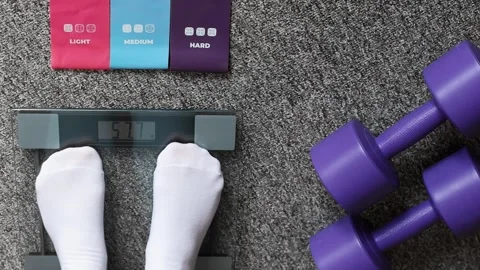 Top view weighing scale with dumbbells, home fitness and weight loss concept. Stock Footage 329586701