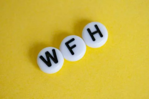 Top view of WFH text representing work from home on yellow background Stock Photos