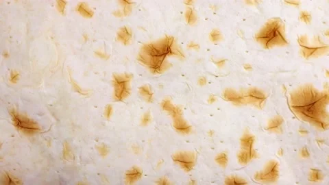 Top view of wheat pita flat bread circle rotation close up Video stock 233997875
