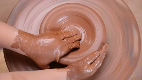 Top view wheel potter hand clay shaping. Close up hands pottery wheel pot clay Stock Footage 158875271