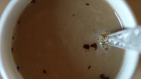 A top view of a white coffee cup filled with Stock Footage 327958859