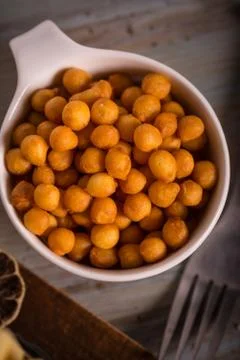 Top view on white cup full of fried chickpeas Stock Photos