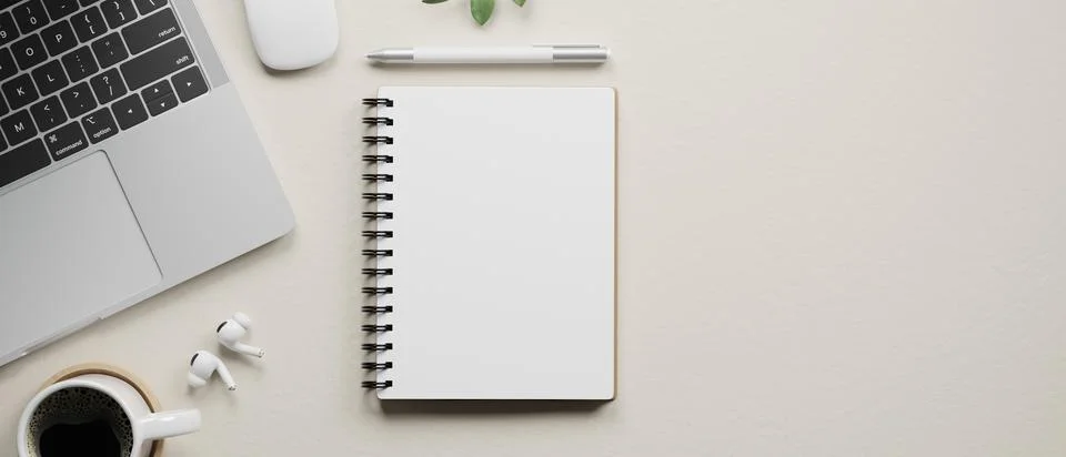 Top view of white desk showing blank notebook with pen, laptop, earbuds and.. Stock Illustration