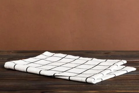 Top view with white empty kitchen napkin isolated on table background. Folded Stock Photos