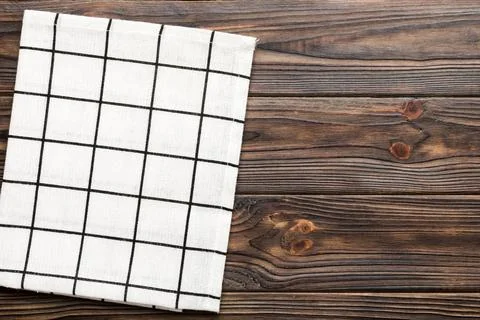 Top view with white empty kitchen napkin isolated on table background. Folded Stock Photos