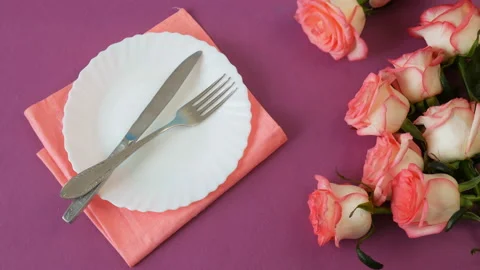 Top view of white empty plate and many pink roses Stock Footage 147438438