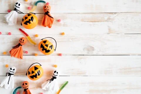 Top view of white ghost  and yellow pumpkins with jelly worm on white wooden Stock Photos