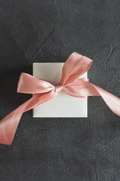 Top view white gift box, adorned with vibrant pink ribbon Stock Photos
