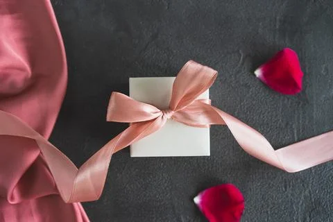 Top view white gift box, adorned with vibrant pink ribbon Stock Photos