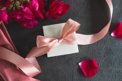 Top view white gift box, adorned with vibrant pink ribbon Stock Photos