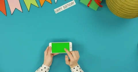 Top view on the white horizontal smartphone lying on the blue table with Happy Video stock 89313665