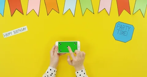 Top view on the white horizontal smartphone on the yellow table with decorations Stock Footage 89329345