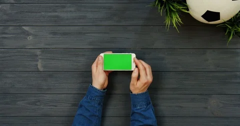 Top view on the white horizontal smartphone with green screen in hands of man Stock-Footage 96311192