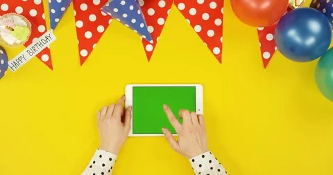 Top view on the white horizontal tablet on the yellow table with birthday Stock Footage 89317441