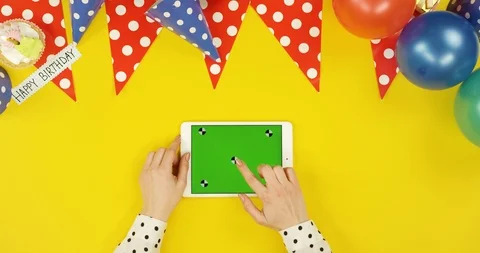Top view on the white horizontal tablet on the yellow table with birthday Stock Footage 89317567