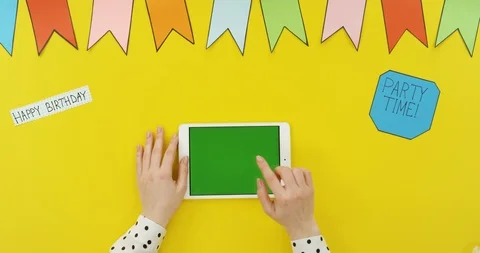 Top view on the white horizontal tablet on the yellow table with decorations Video stock 89335285
