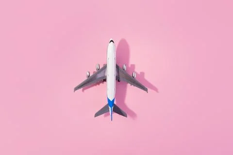 Top view of white model plane, airplane toy on isolated pink background. Fl.. Stock Photos