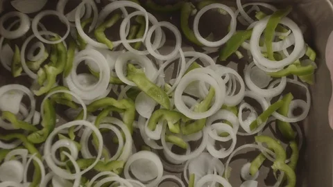 Top view white onion rings and green bell pepper fly up. Slow motion video Stock Footage 114307290