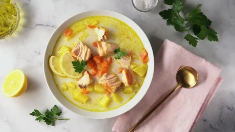 Top view of white plate with delicious creamy salmon soup and ingredients Stock Footage 138336004