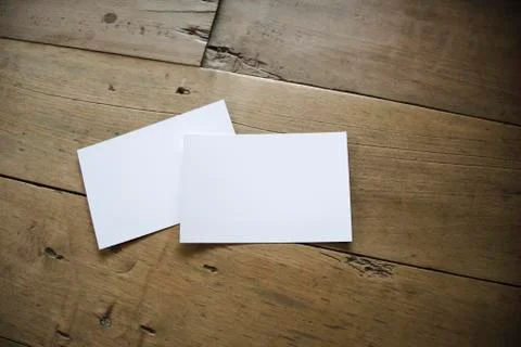 Top view of white postcard or papers on old wooden background Stock Photos