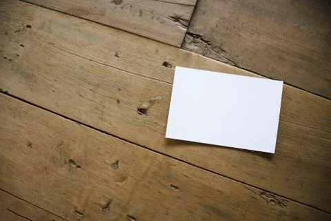 Top view of white postcard or paper on old wooden background Stock Photos