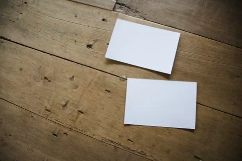 Top view of white postcard or papers on old wooden background Stock Photos