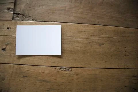 Top view of white postcard or paper on old wooden background Stock Photos
