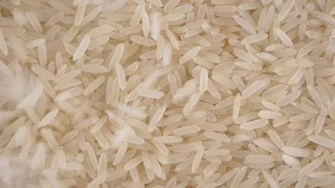 Top view of white rice falling on a table , Stock Footage 333605213