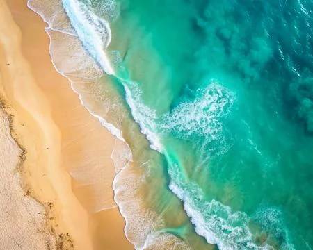 Top view of the white sand beach and the rolling foamy wave of the ocean. Stock Photos