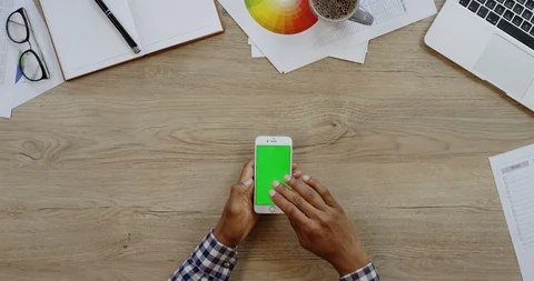Top view of the white smartphone lying vertically on the wooden office table Video stock 96003590