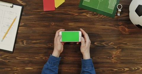 Top view on the white smartphone lying horizontally on the wooden table with Video stock 96315799