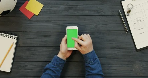 Top view on the white smartphone lying vertically on the dark grey wooden table Video stock 96330421