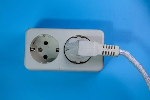 Top view of white socket on blue background Stock Photos