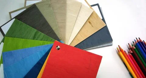 Top view of white surface with open fabric color chart sample and color penci Stockfoto's