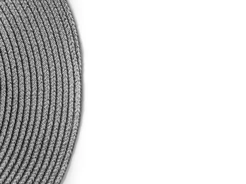 Top view on white table with round gray modern wicker tablecloth with free sp Stock Photos