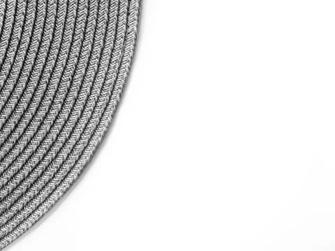 Top view on white table with round gray modern wicker tablecloth with free sp Stock Photos
