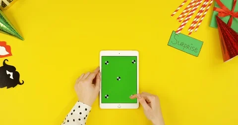 Top view on the white tablet computer on the yellow table with birthday party Stock Footage 89319748