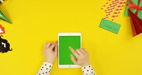 Top view on the white tablet computer on the yellow table with birthday party Stock Footage 89320174
