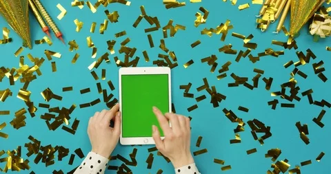 Top view on the white tablet device with green screen lying on the blue table Video stock 89306511