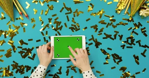 Top view on the white tablet device with green screen lying on the blue table Stock Footage 89307102